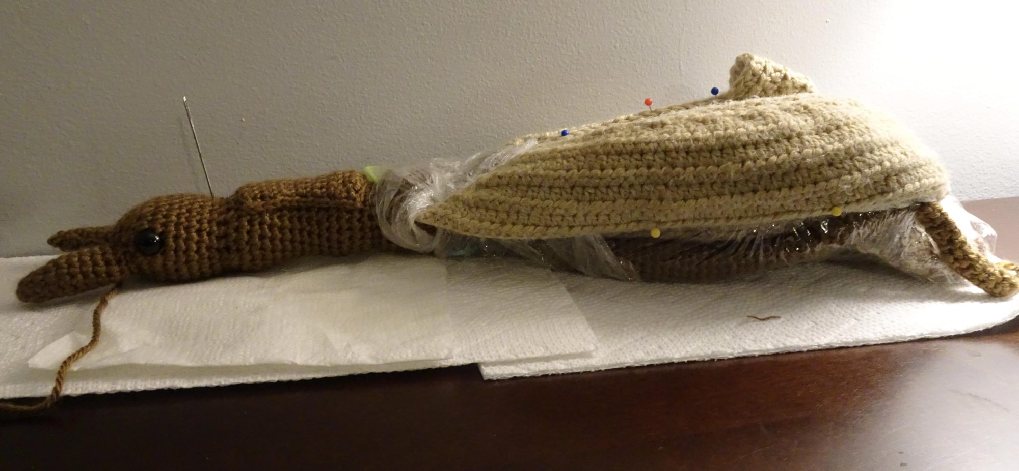 Crochet project with pins holding fabric in place.