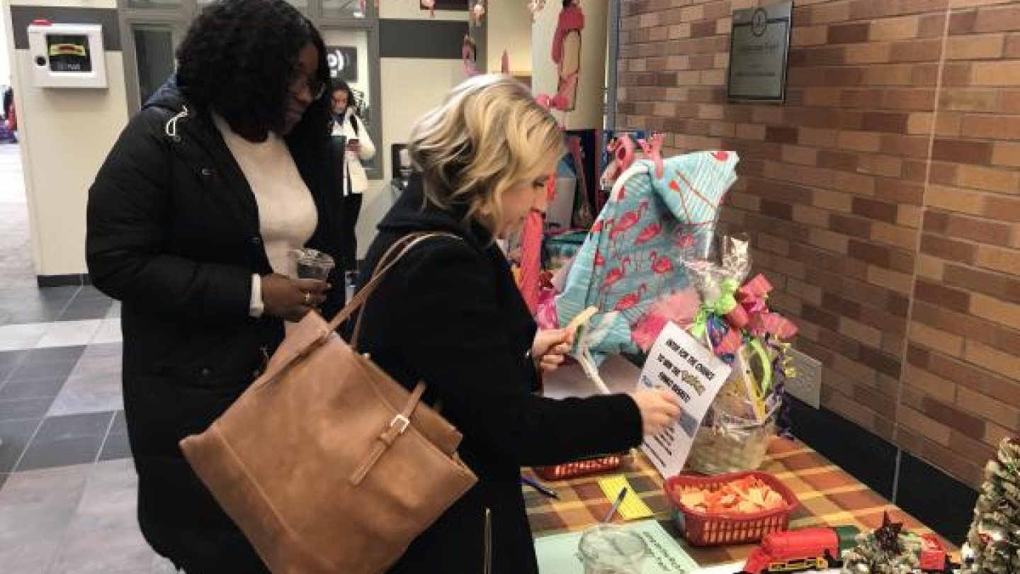 Two women looking at baskets available for raffle