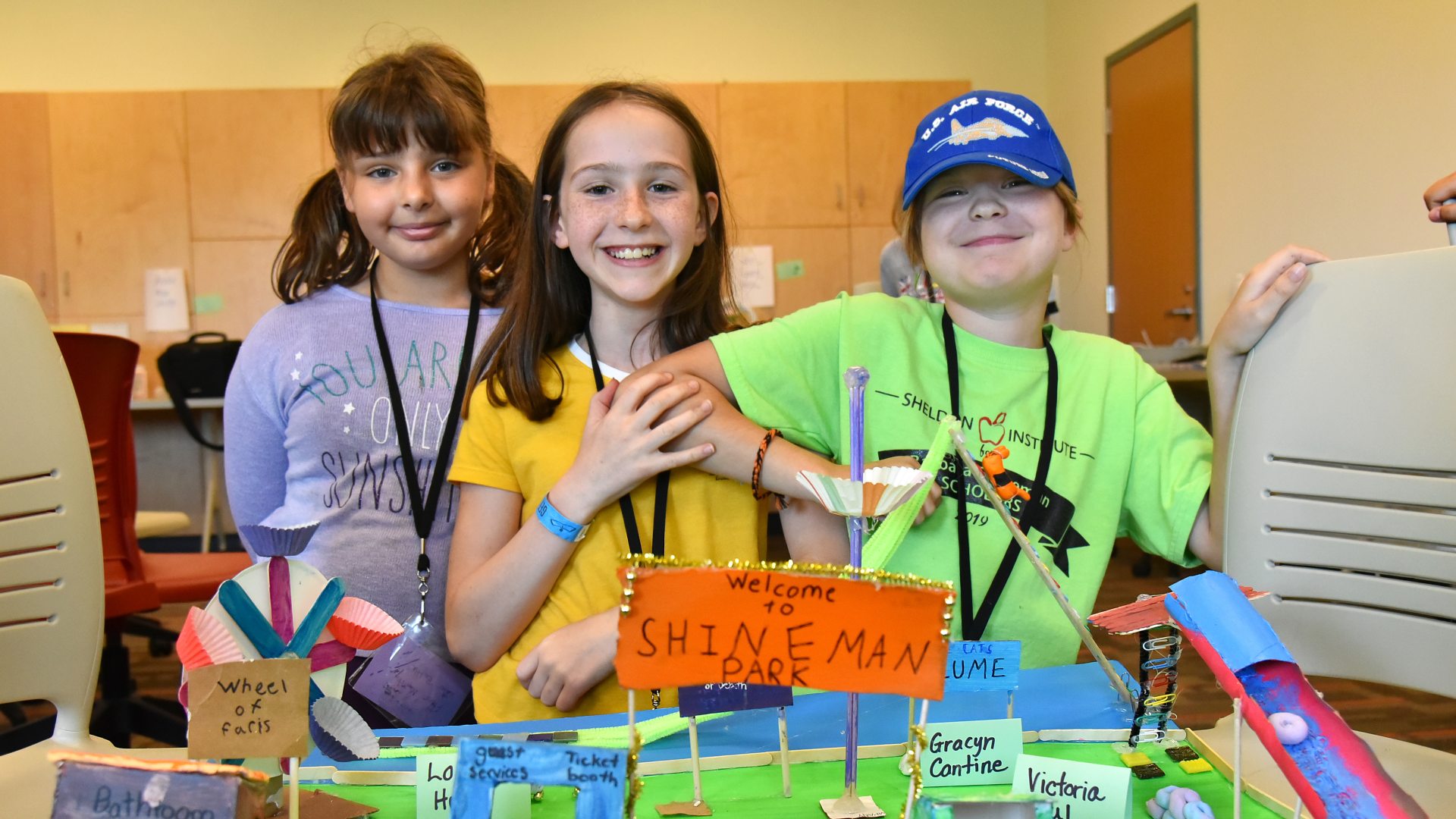 Three young students displaying a Shineman Park model