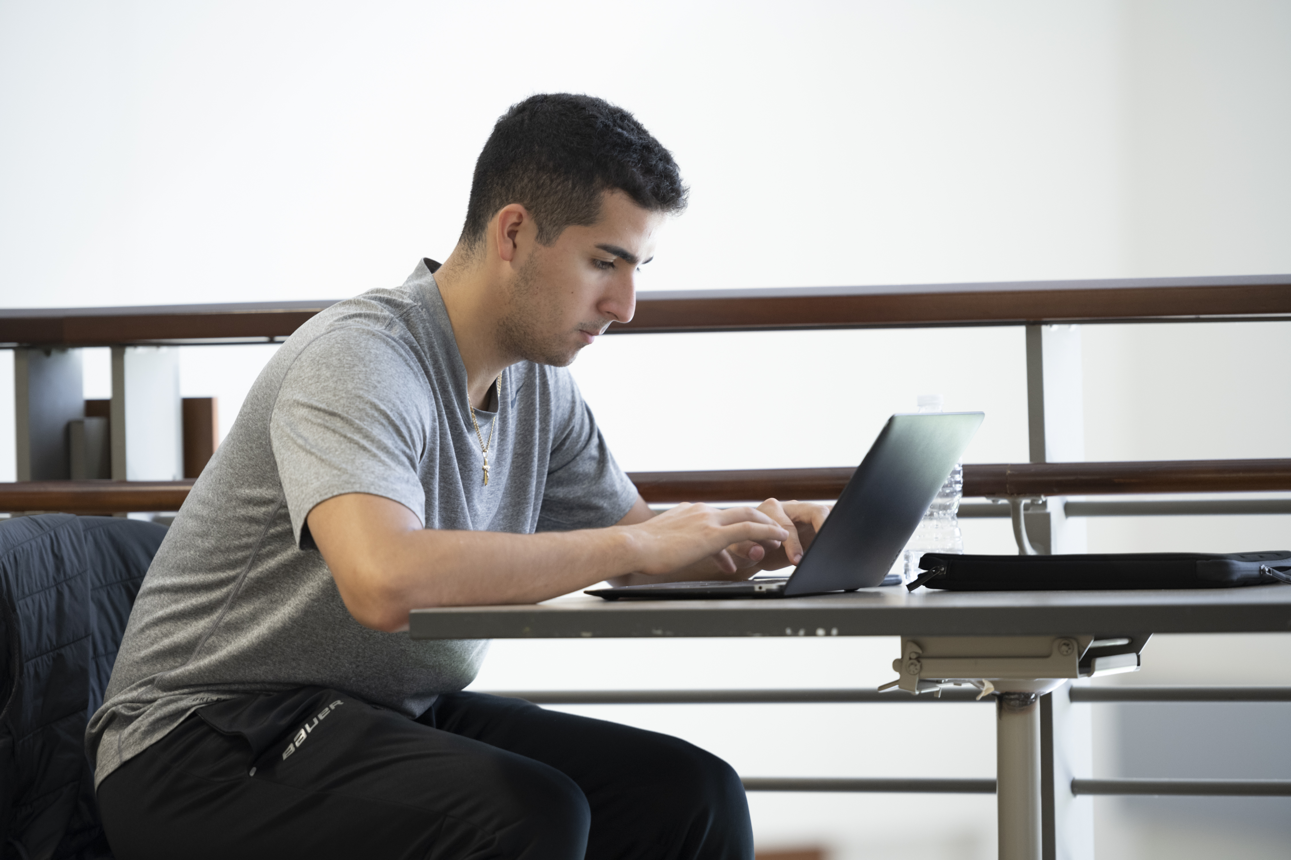 male student working on laptop