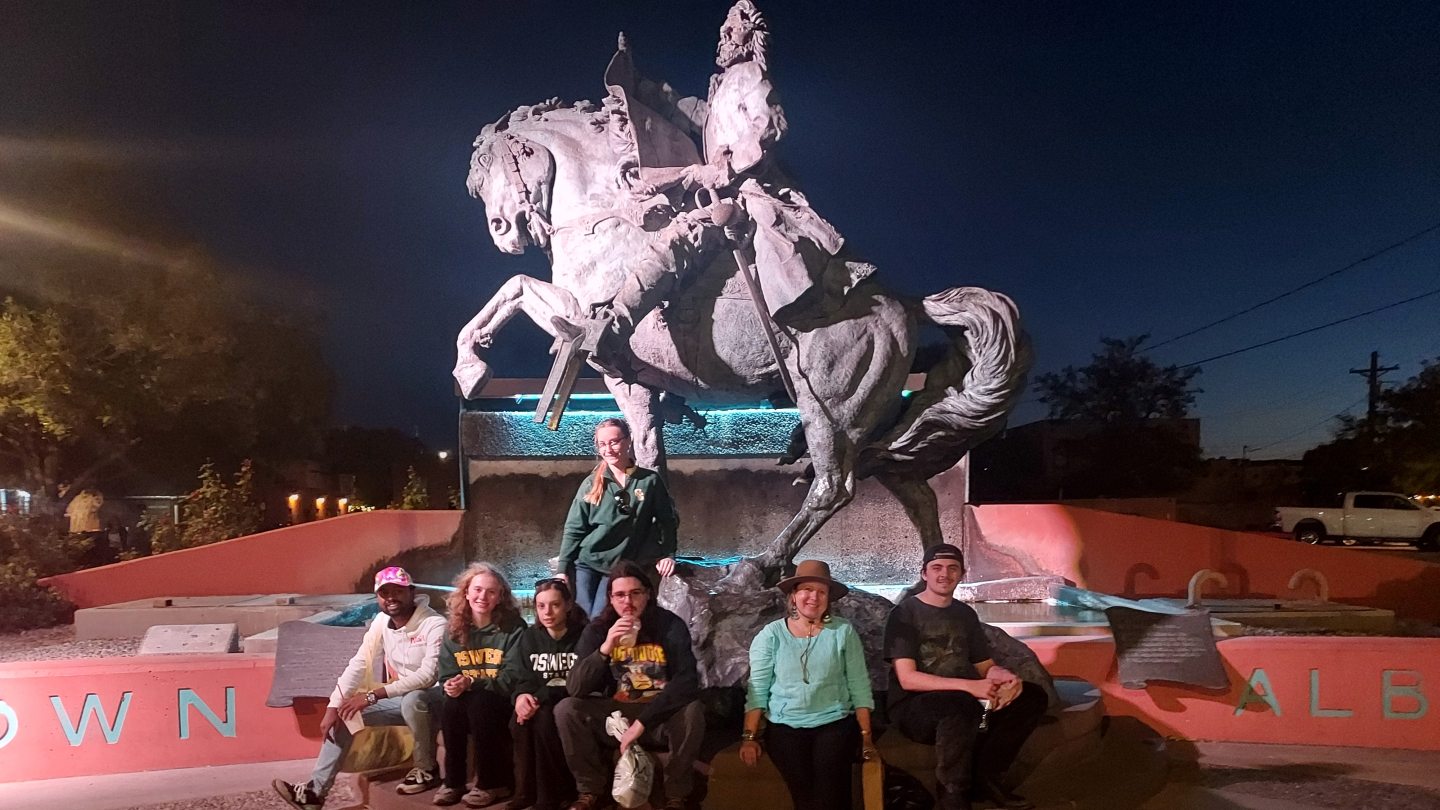 SUNY Oswego students in front of a soldier's statue in Albequerque, New Mexico