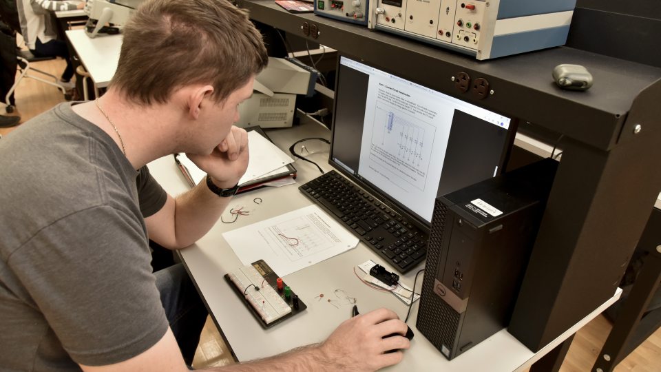 male student working on a computer