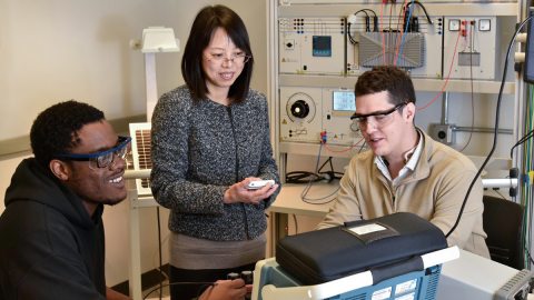 ECE faculty member Hui Zhang works with studentsChibuike Ogbonna and Avery Croucher, after earning National Science Foundation funding for research to improve electric vehicle charging.