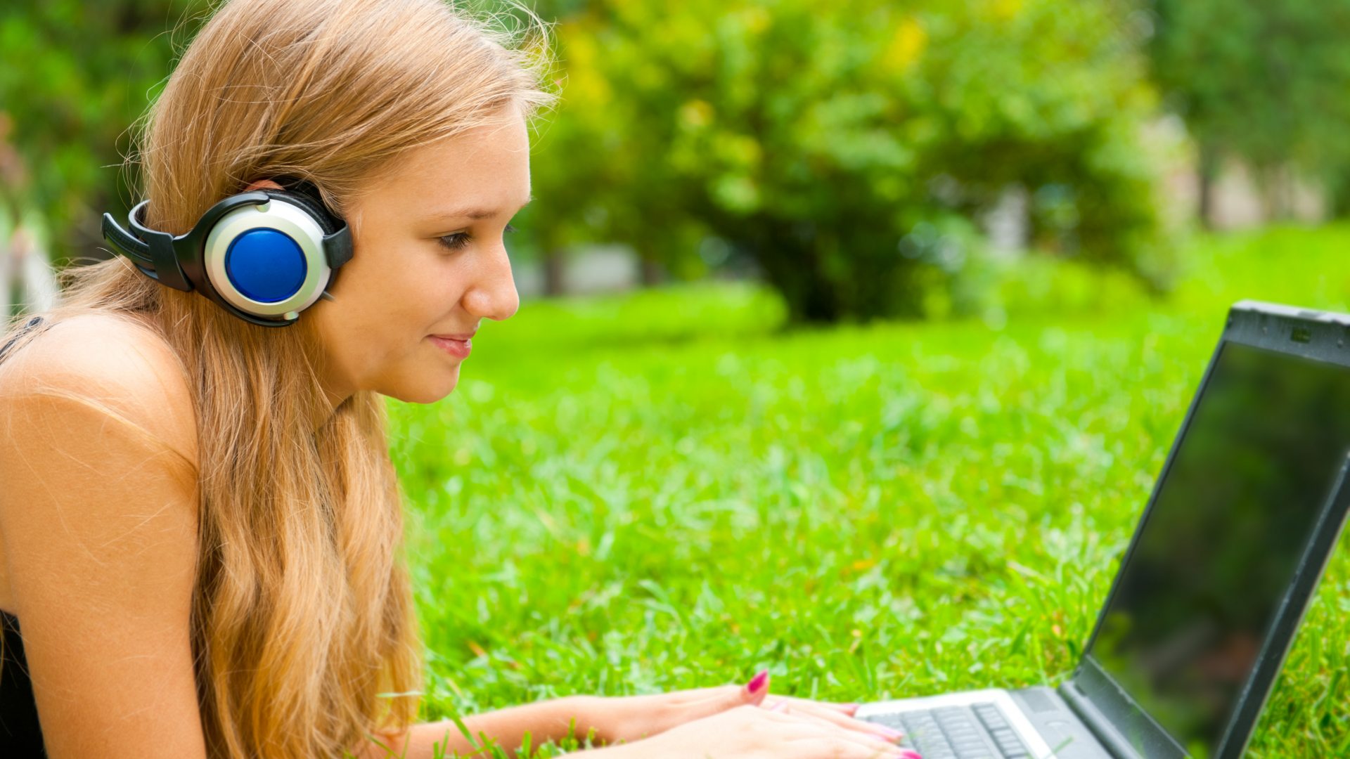 student on laptop with headphones