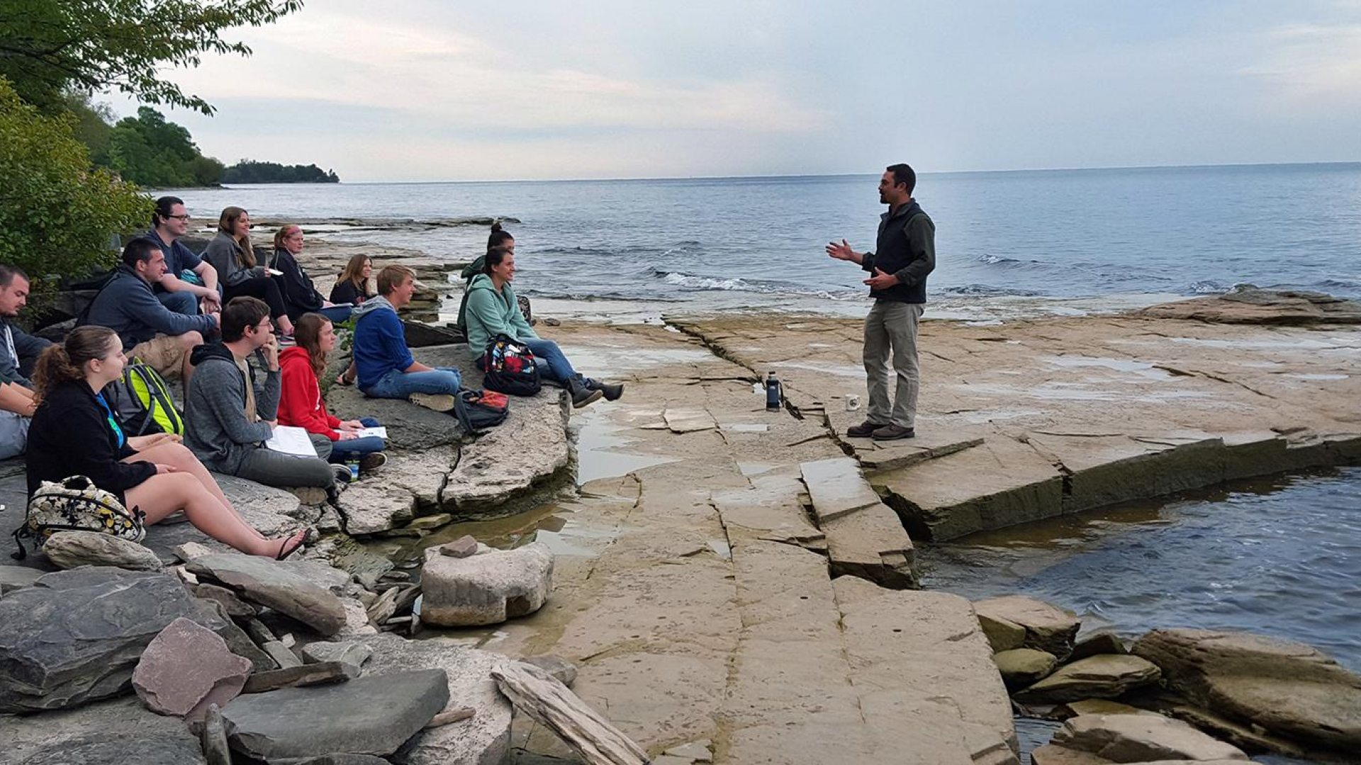 Professor and students near Lake Ontario