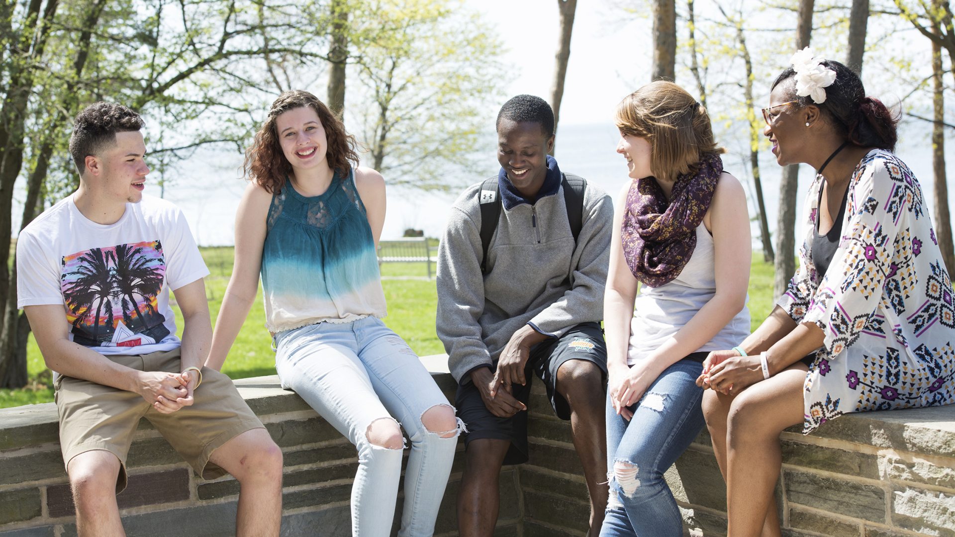 Students on lakeside wall