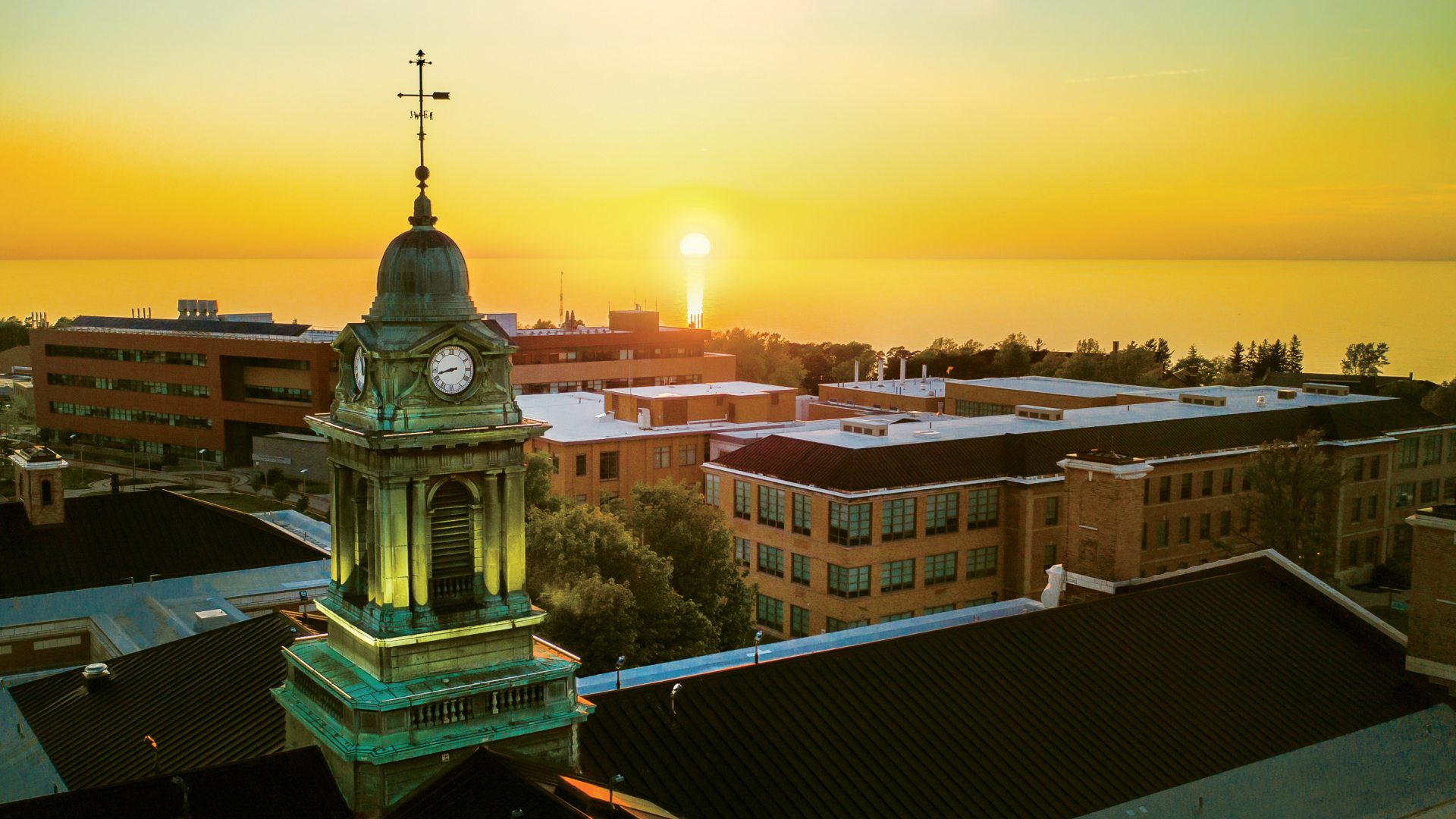a sunset behind the cupola of Sheldon Hall