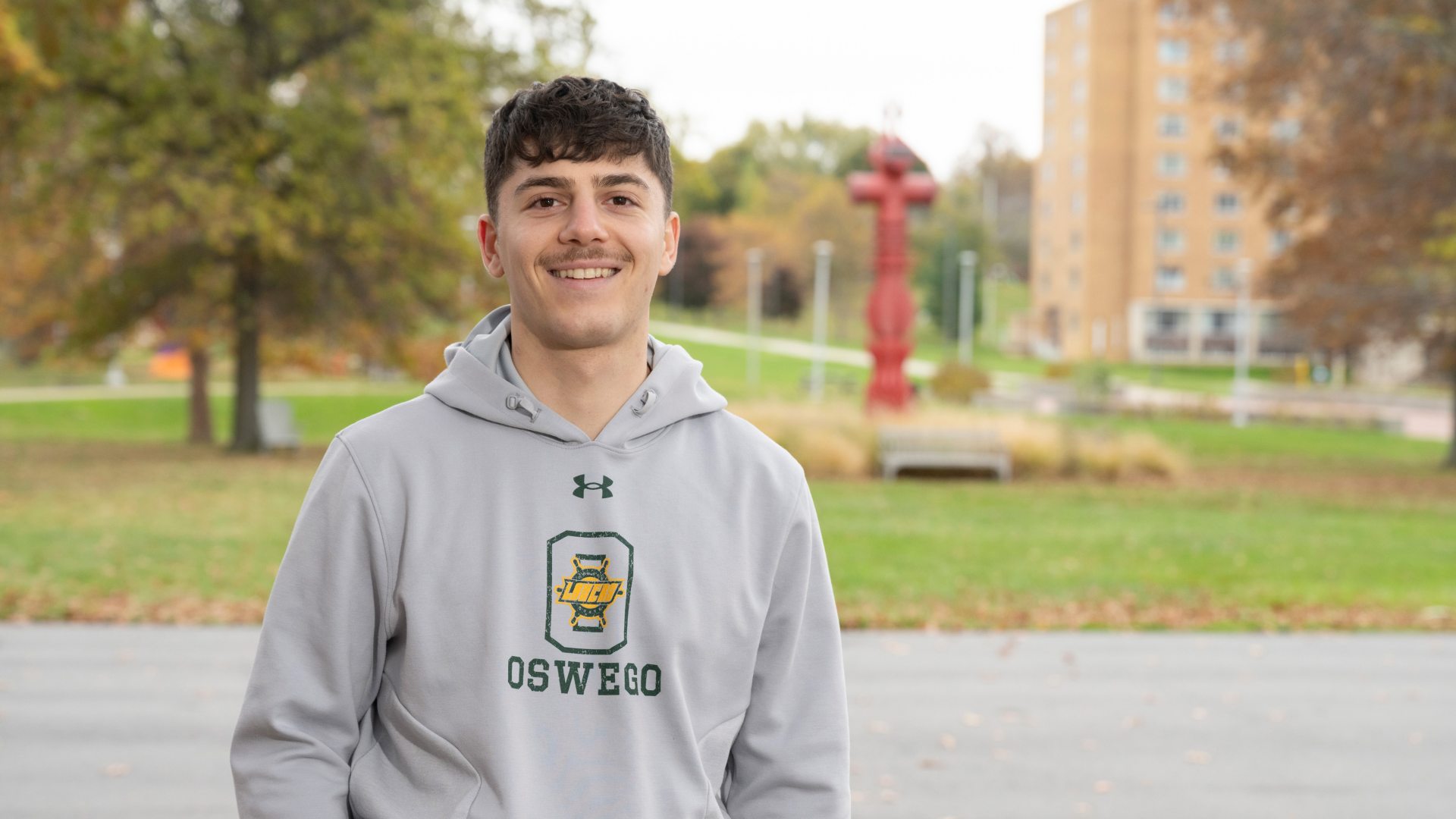 student paul lomanto standing outside