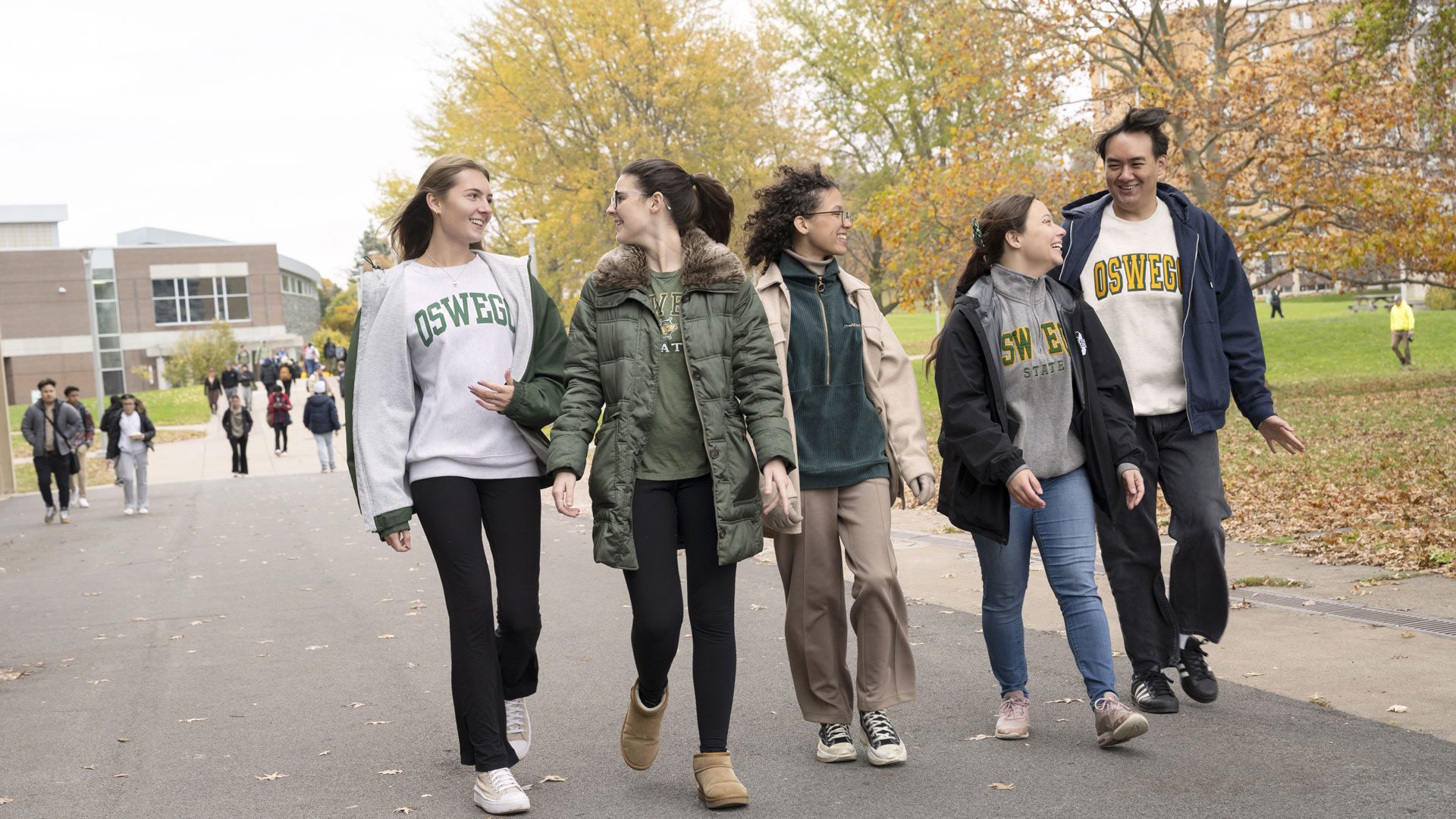 Oswego students chat while heading to class on a crisp fall day.