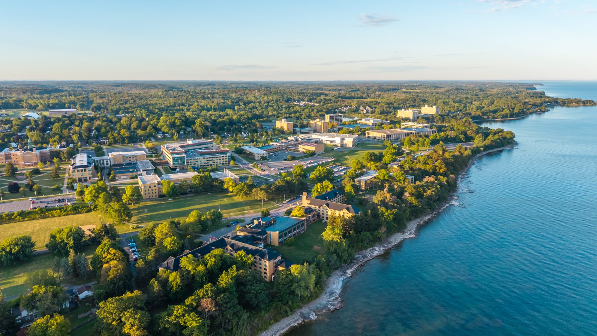 drone photo of the lake shore and Oswego campus