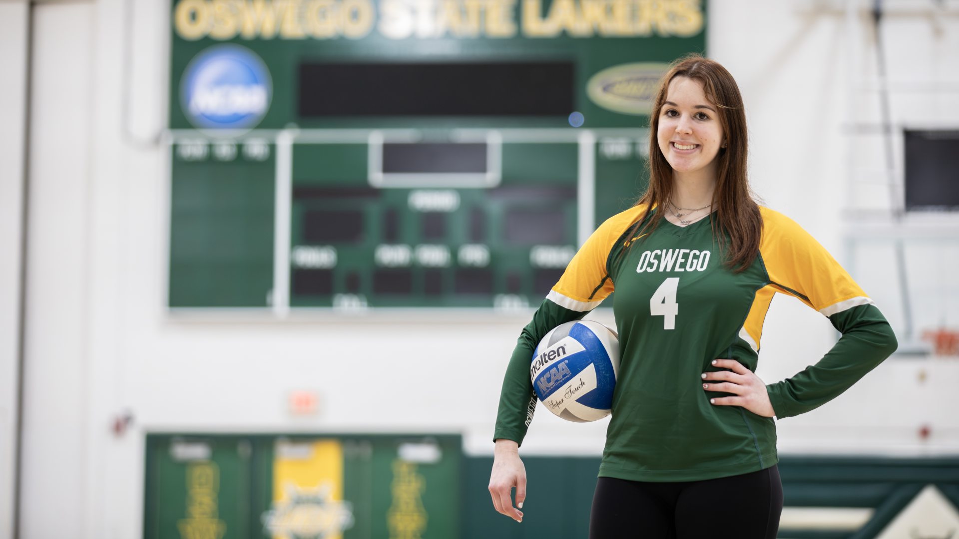 Student athlete posing with a volleyball