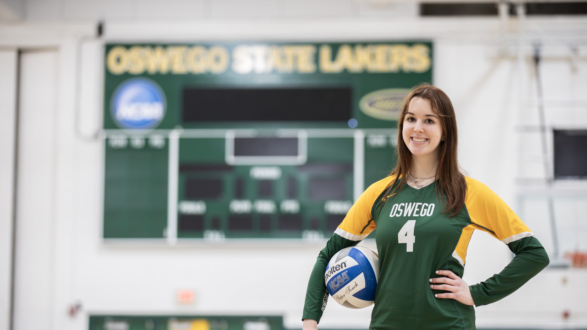 Student athlete posing with a volleyball
