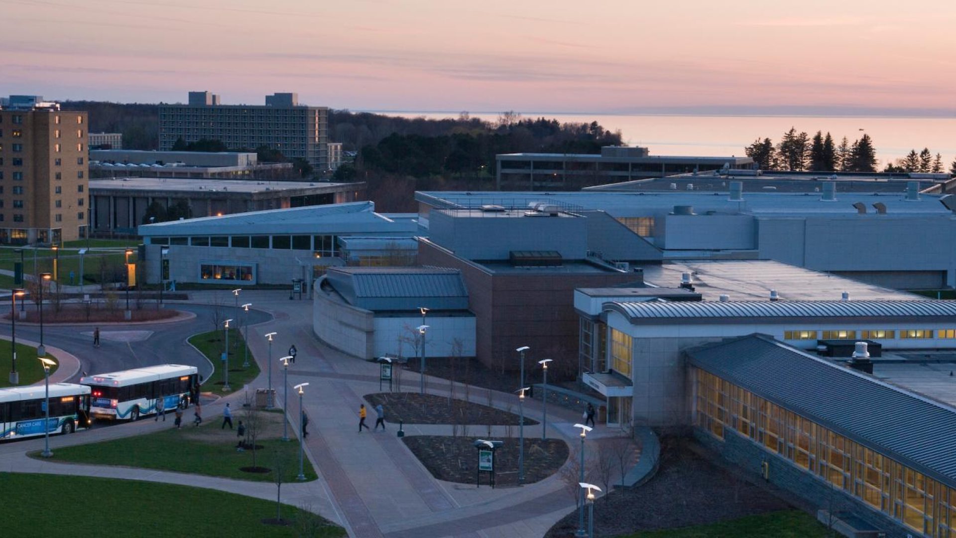 Aerial view of campus at dusk, looking over Marano Campus Center toward Lake Ontario