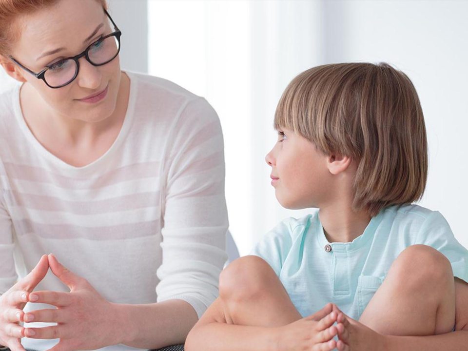 A woman and a young child looking at each other
