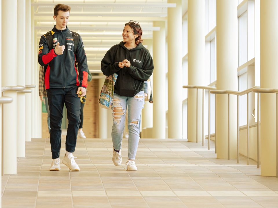 Students in a sunlit Campus Center corridor