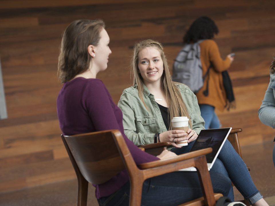 three female students sitting down talking