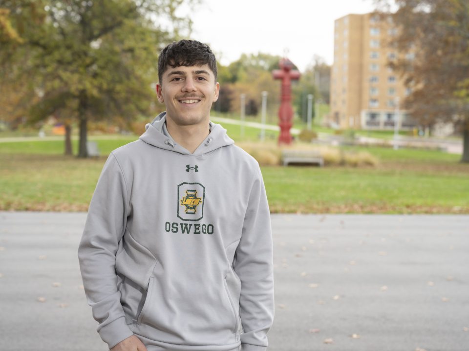 male student standing in the quad