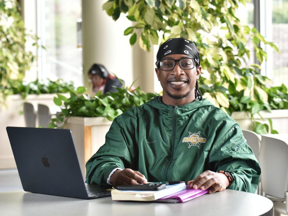 male student studying at a laptop