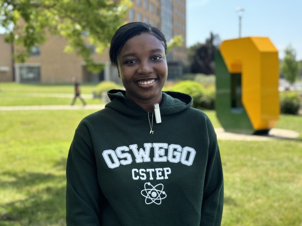 female student standing outside in front of the spirit O