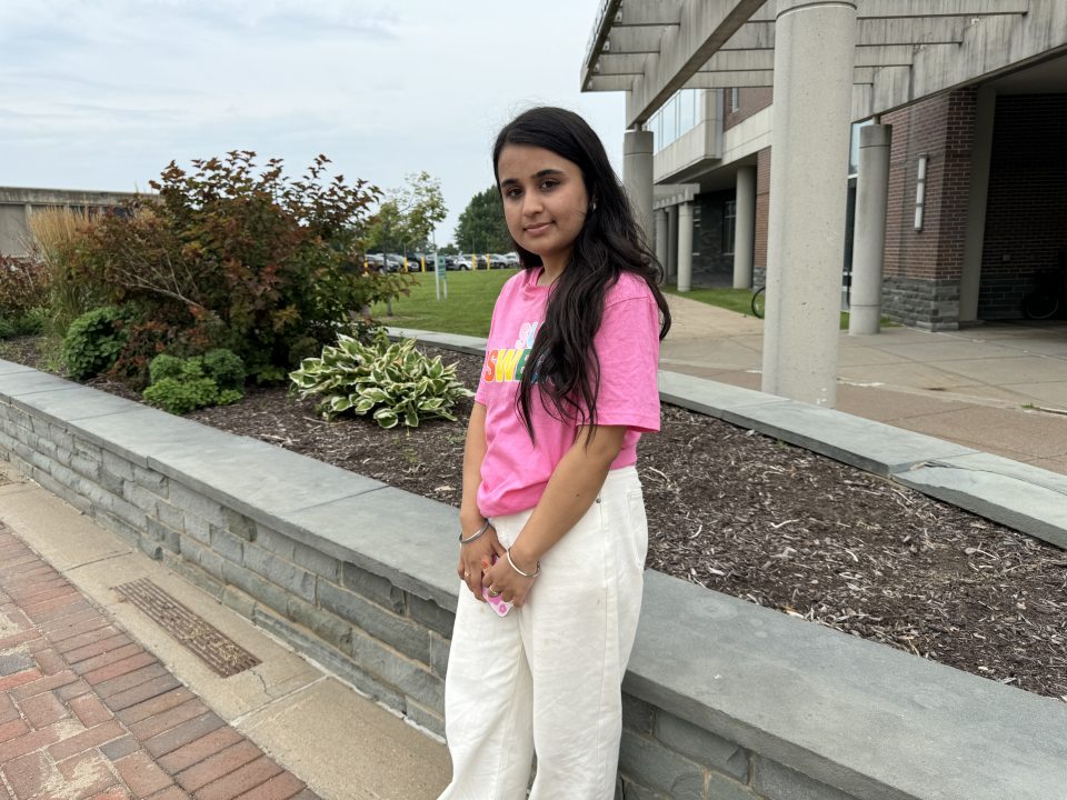 female student standing in the quad