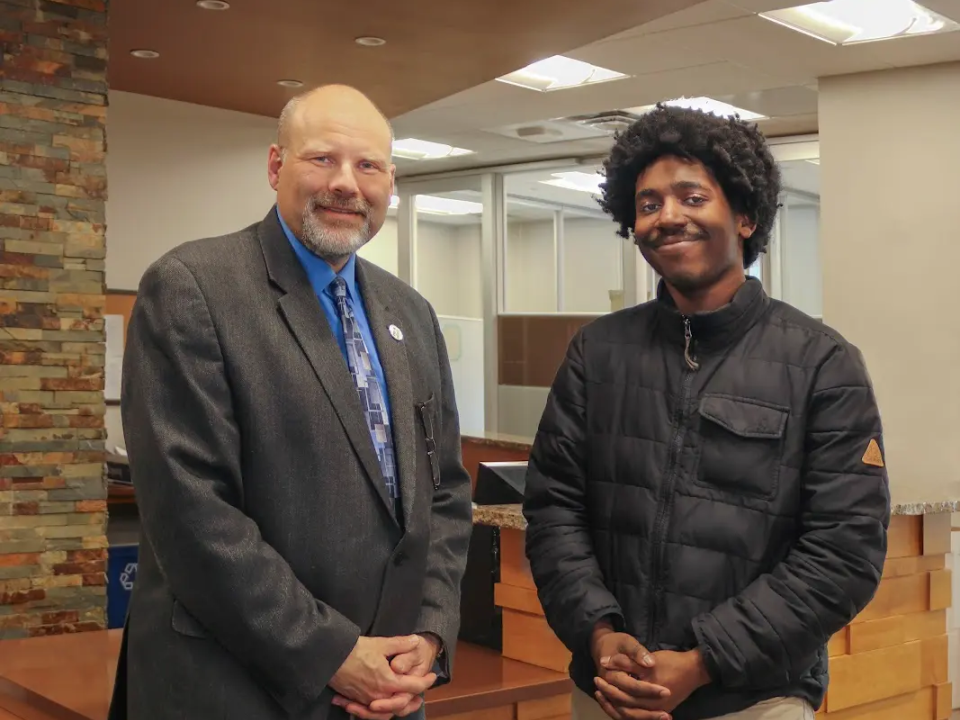 Ziaire Beckham standing with another person in a professional office setting