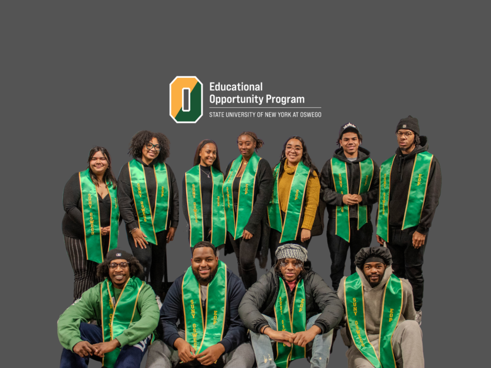 A group of students wearing green stoles representing EOP