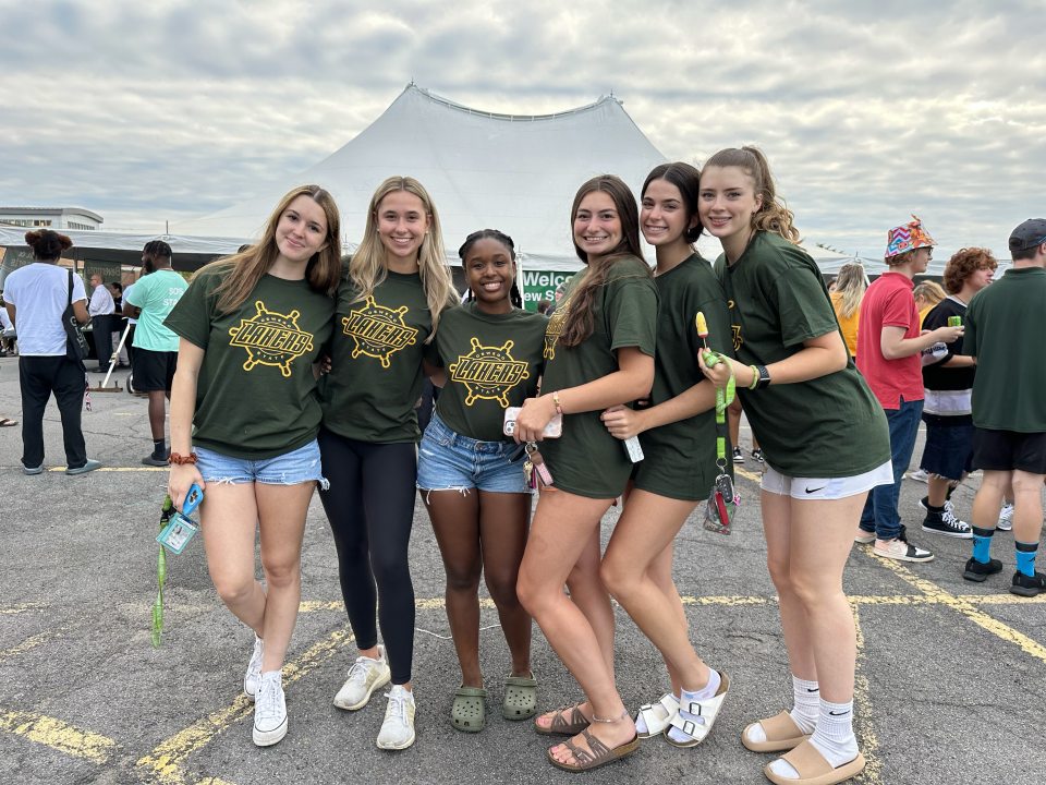 Students outside tent on SUNY Oswego Campus 