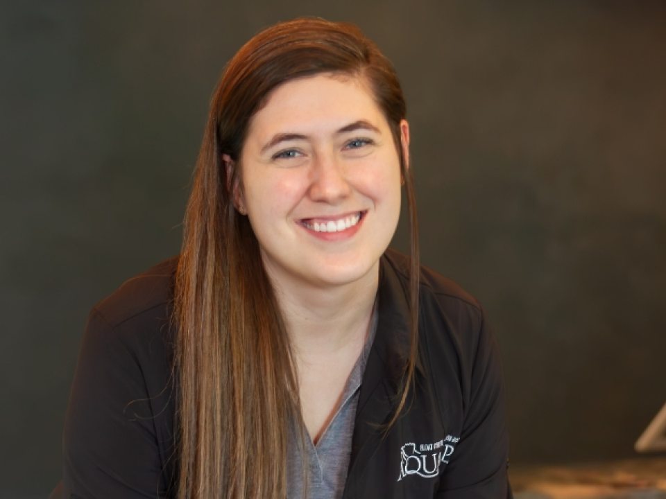 Alumna Katie Mahaffey stands inside Aqua Spa Float Center.