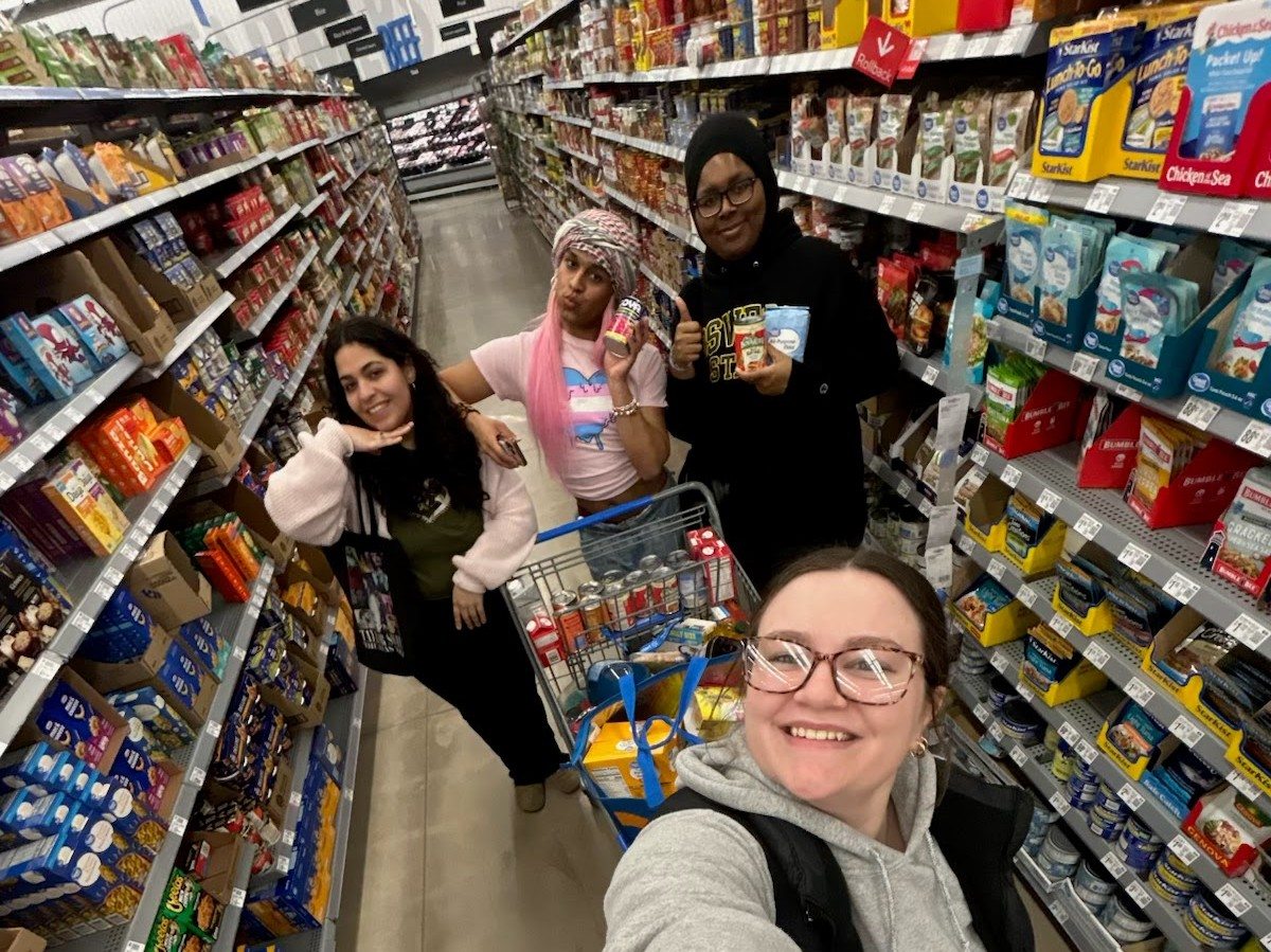 Four Soc Club members shopping for a food drive