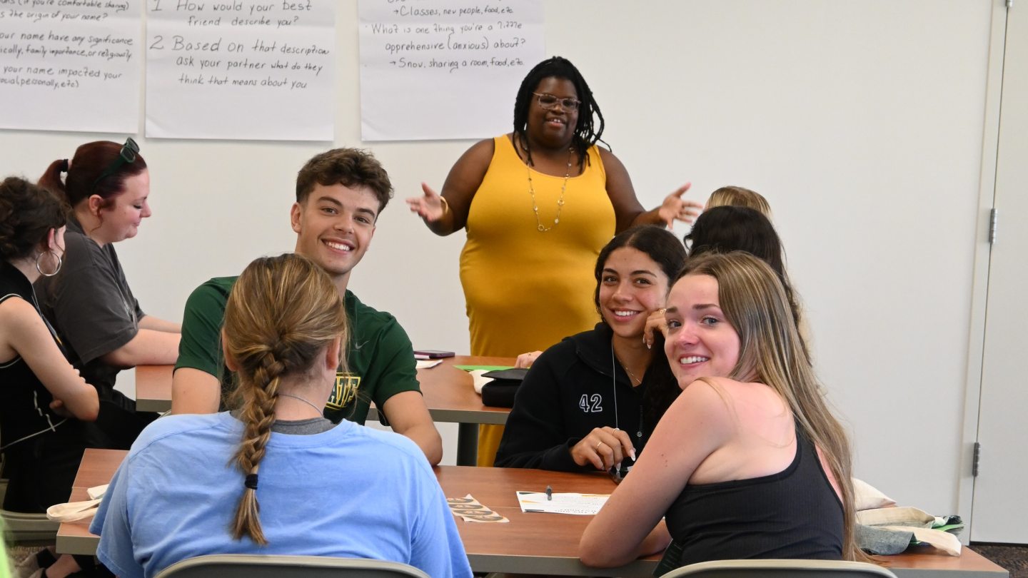 A group os students smiling as they get to know each other at Summer Orientation