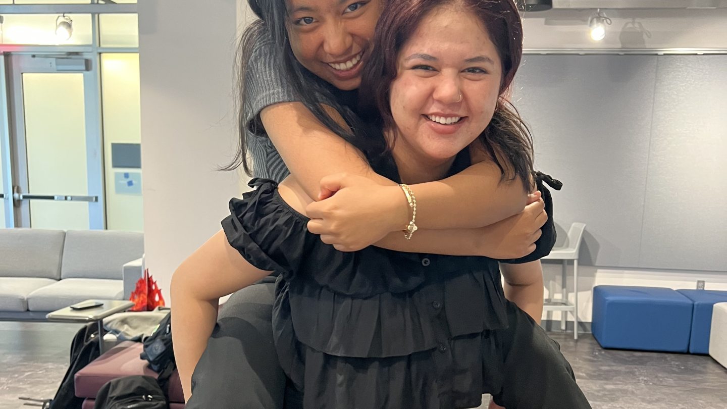 Two Orientation Leaders smiling into the camera