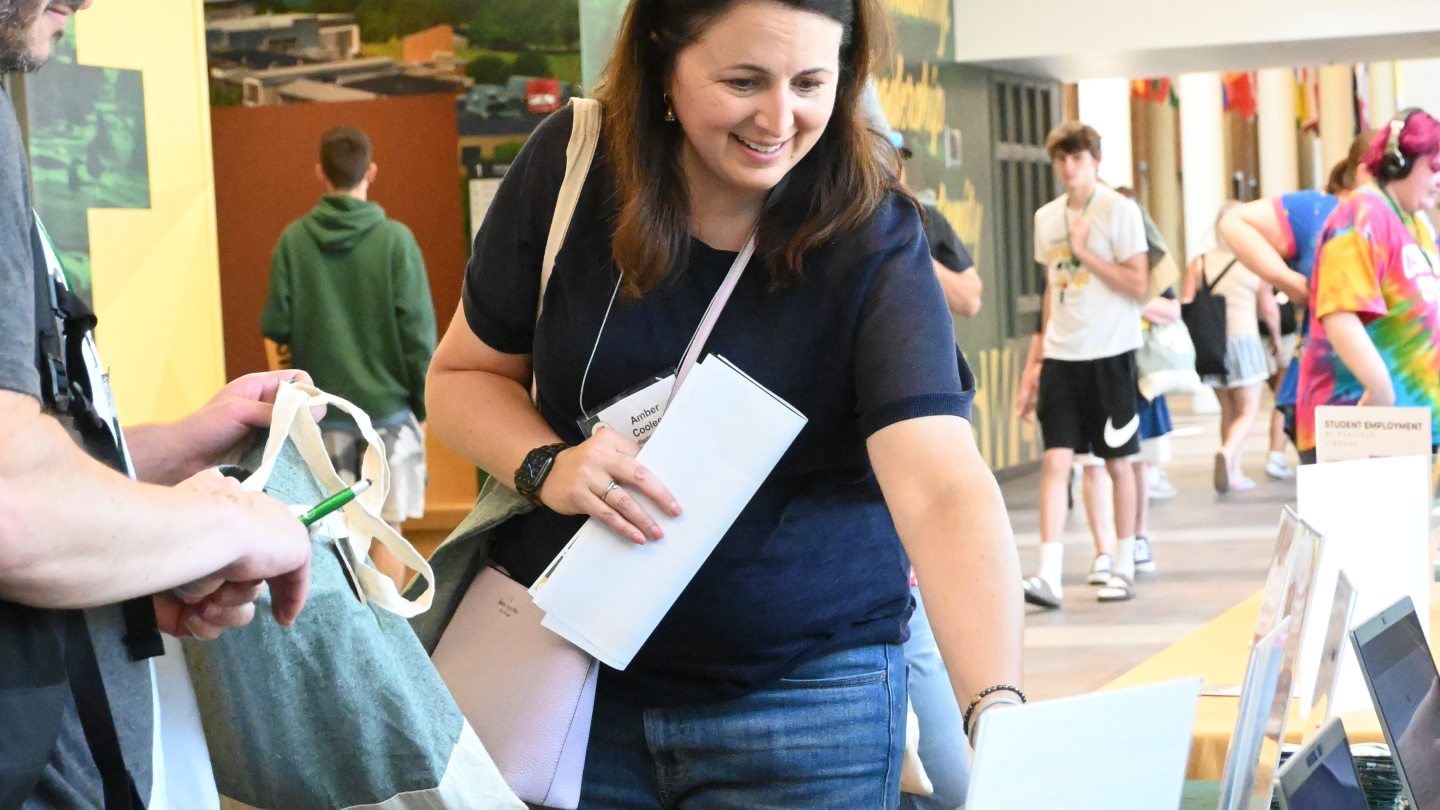 Parents at a table asking questions to a department representative