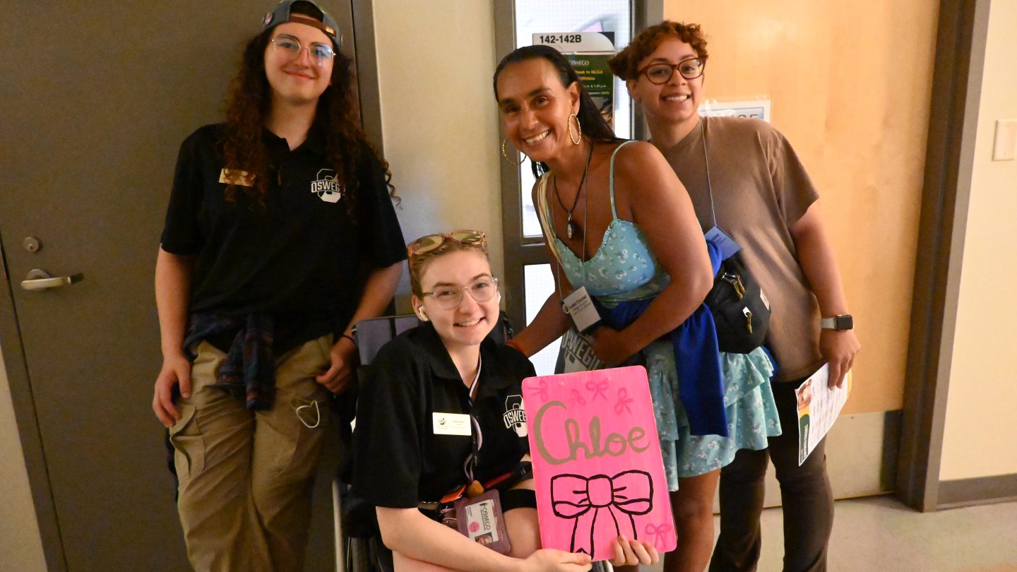 Orientation Leaders and attendees standing outside a classroom