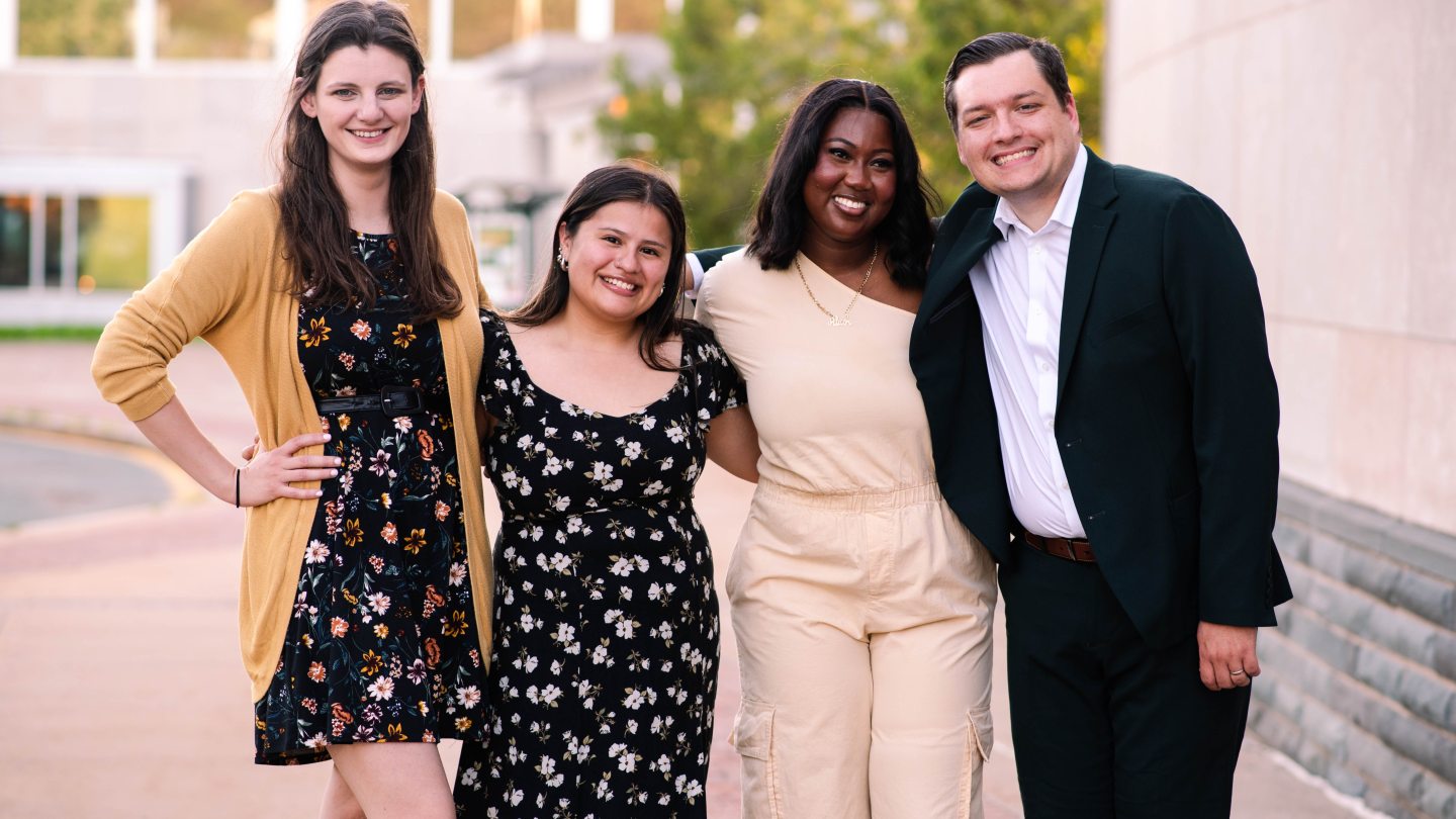 Pro Staff dressed up, smiling and looking into the camera
