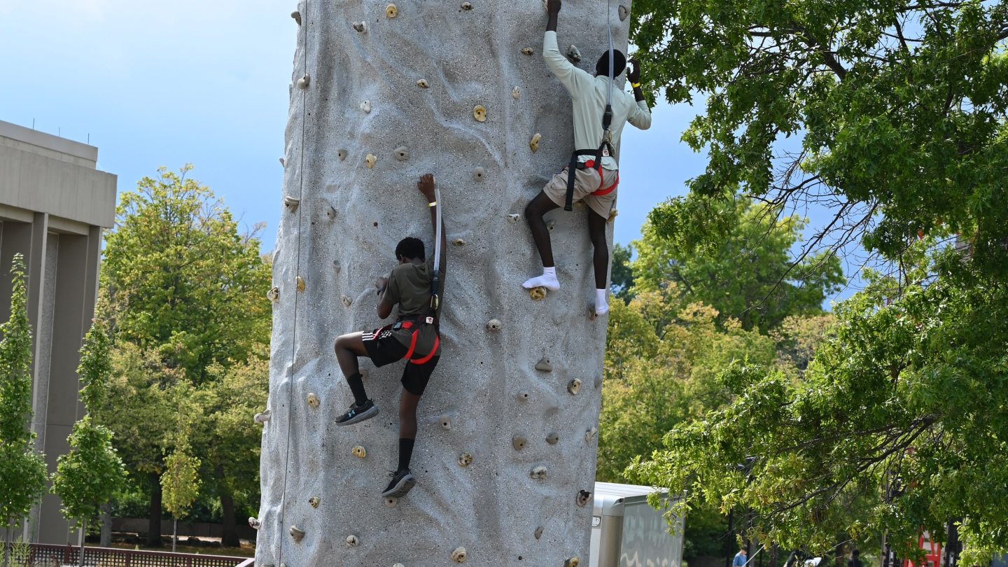 Two students rock wall climbing