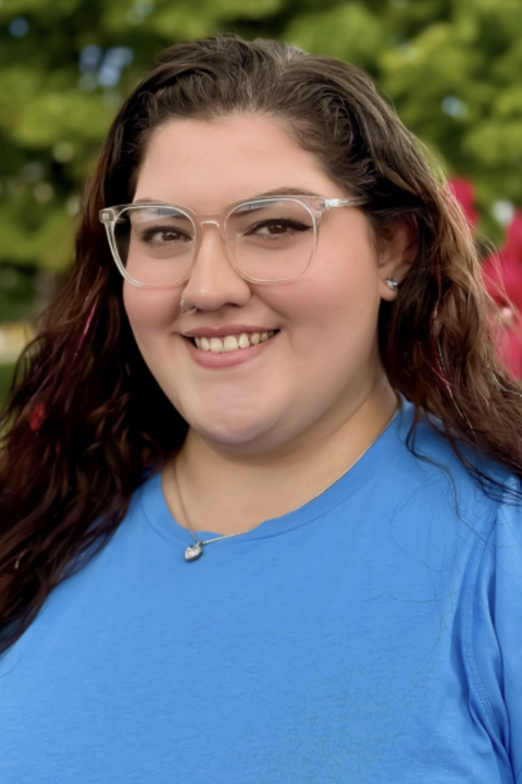 Headshot of Ari Brookshire Alicea wearing a blue shirt