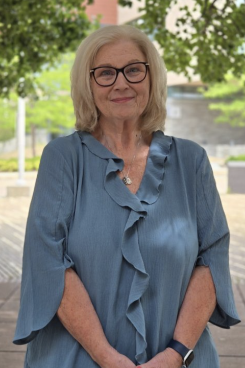 Headshot Kate Colucci with a blue shirt