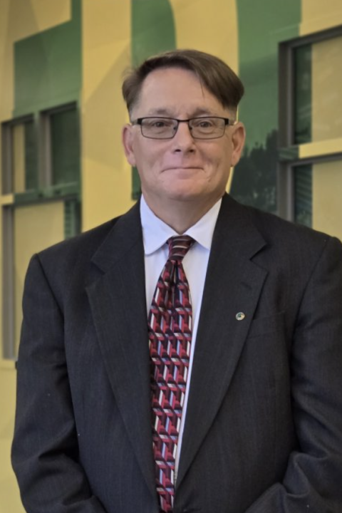 Headshot of Pat Devendorf wearing a suit