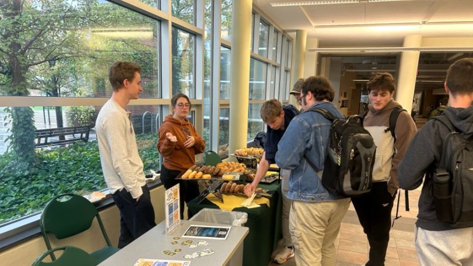 A group of people gathered at an event table