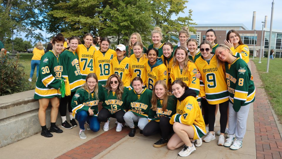 A group of students wearing yellow or green jerseys