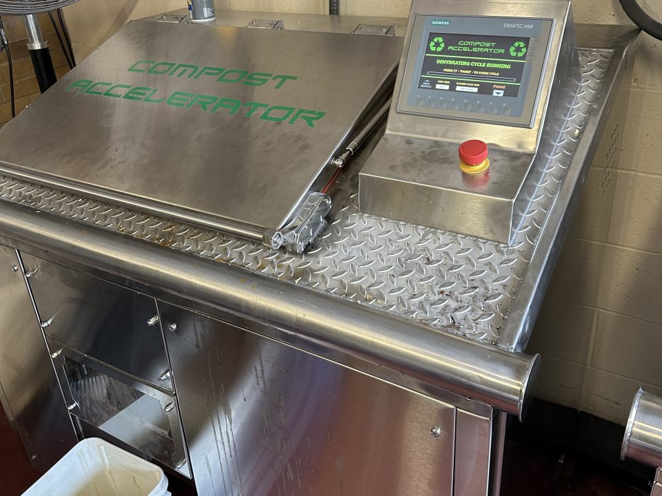 machine used to dehydrate food scraps with text stating compost accelerator