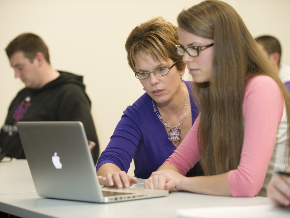 Amy bidwell working with student