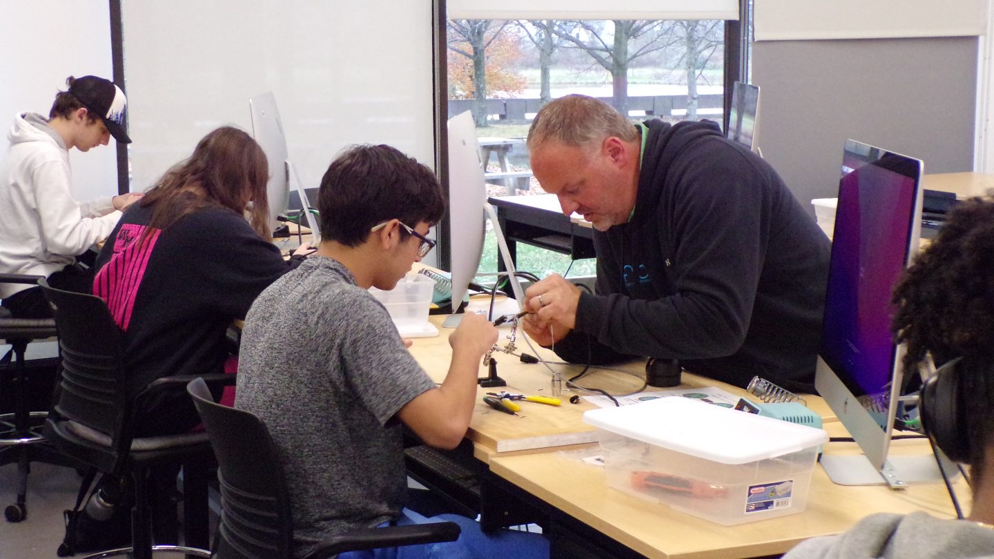 Student learning to solder