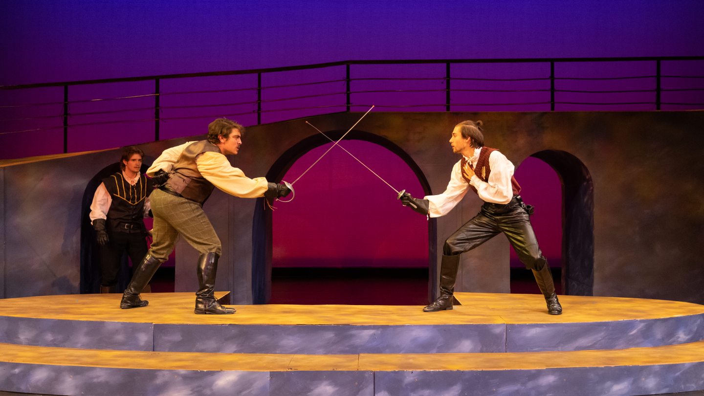 Two figures fencing