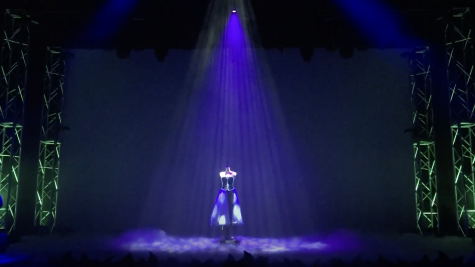 Dress form down lit surrounded by truss