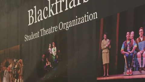 Blackfriars student theatre organization banner on stage with its members