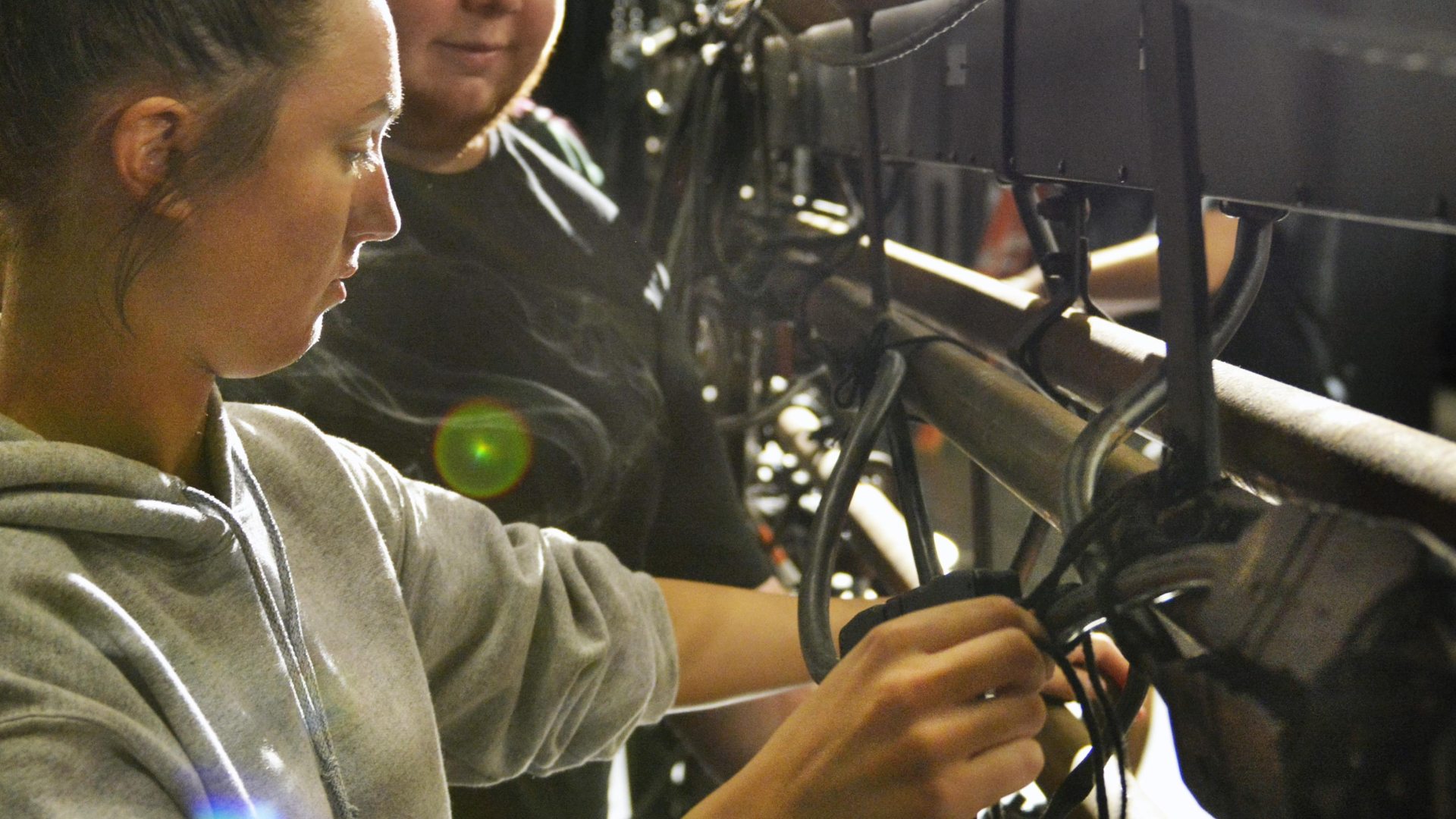 student from theatre class focusing on working on stage equipment 