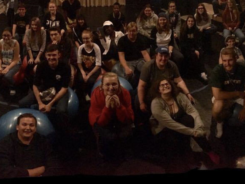 Students of the Theatre Executive Council sitting in a group smiling at the camera
