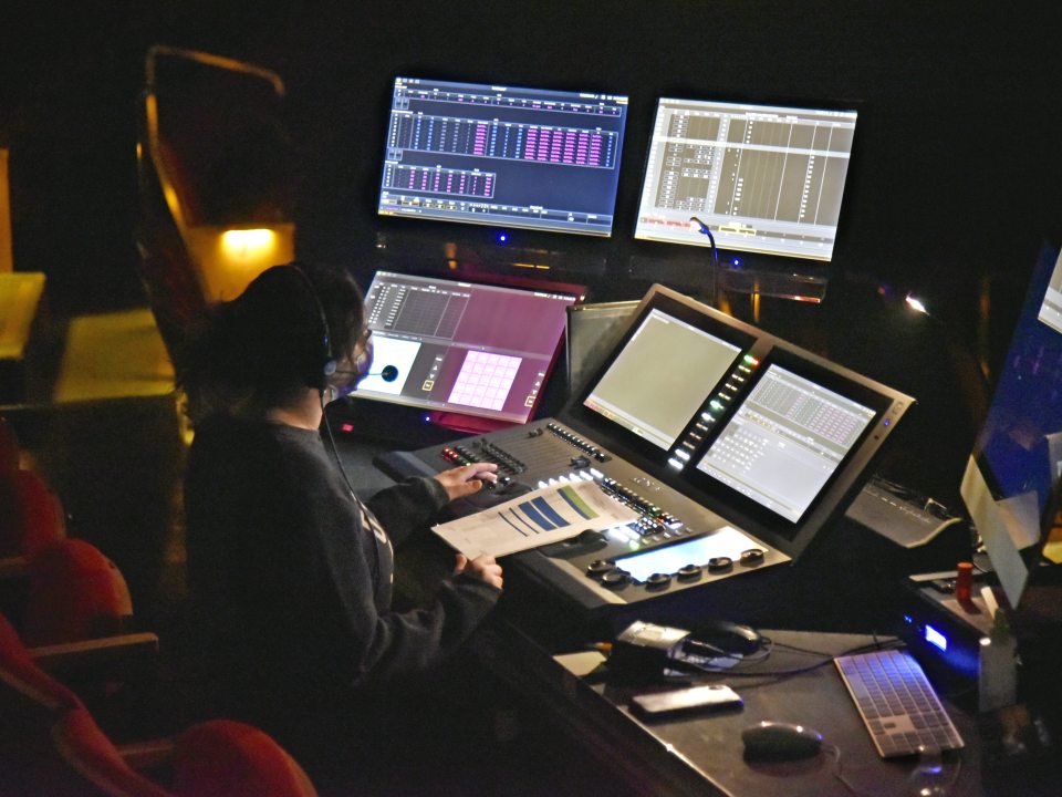 Student sitting at a light board
