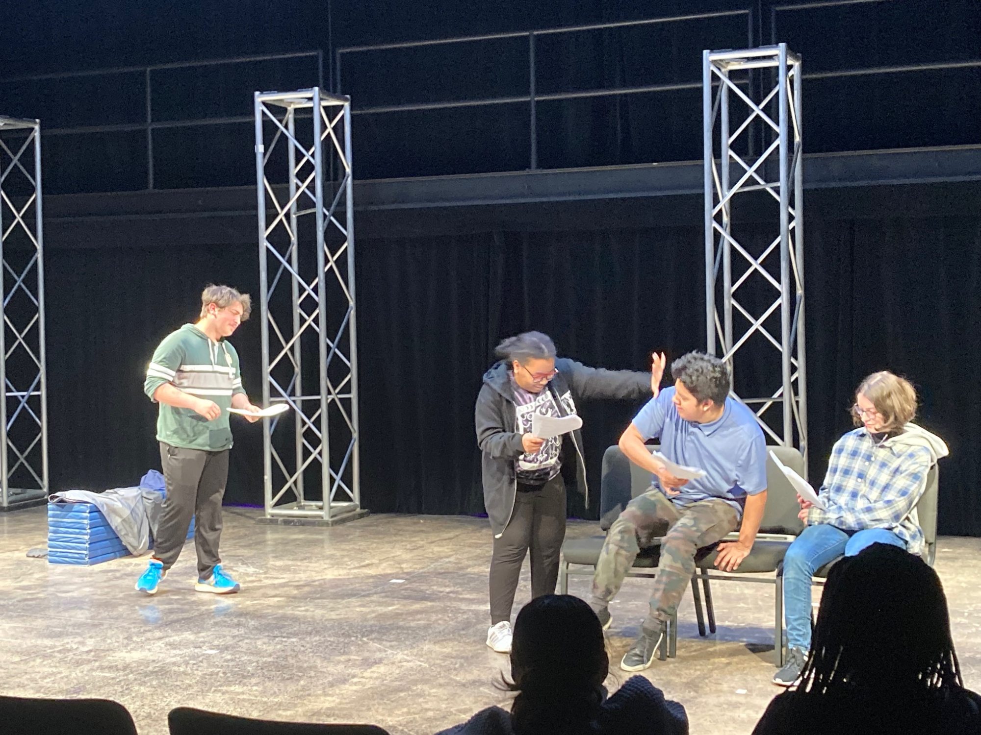 Students performing with scripts in hand